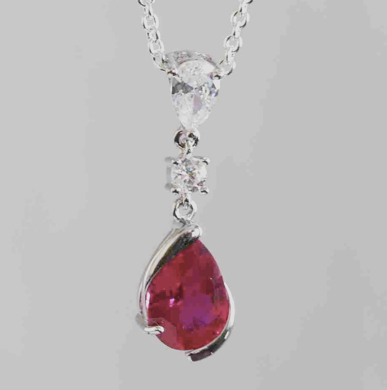 Sterling Silver Pear Shaped Ruby Lab Created Non-Treated Pendant Accented with Two Round Cubic Zirconia Stones 925ijewel.com