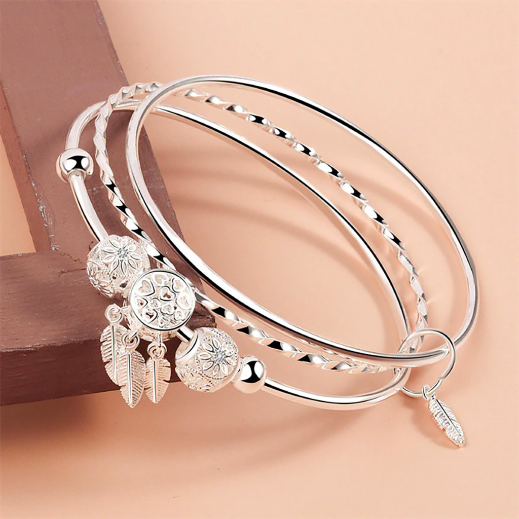 Premium Sterling Silver – Crafted from high-quality 925 sterling silver for durability and shine. Slip-On Comfort – Easy-to-wear design ensures a secure and comfortable fit. Triple Bangle Design – Unique layered look adds depth and elegance. Diamond-Cut Beads – Five shimmering beads that sparkle beautifully in the light. Feather Charms – Four hanging feathers symbolizing freedom, grace, and individuality. Versatile Style – Perfect for both casual wear and special occasions. 925ijewel.com