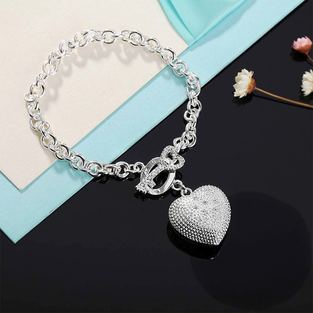 Key to My Heart Sterling Silver Puffed Heart Bracelet with Cut-Out Hearts and Florentine Finish. 925ijewel.com