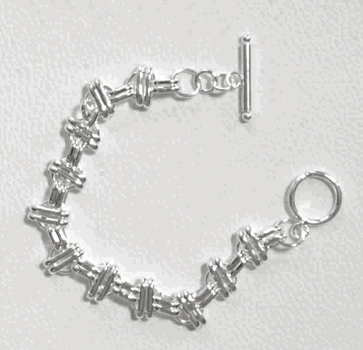 Sterling Silver Interlinked Grace Double Bar and Spaced Circles Bracelet with Toggle Clasp. 925ijewel.com